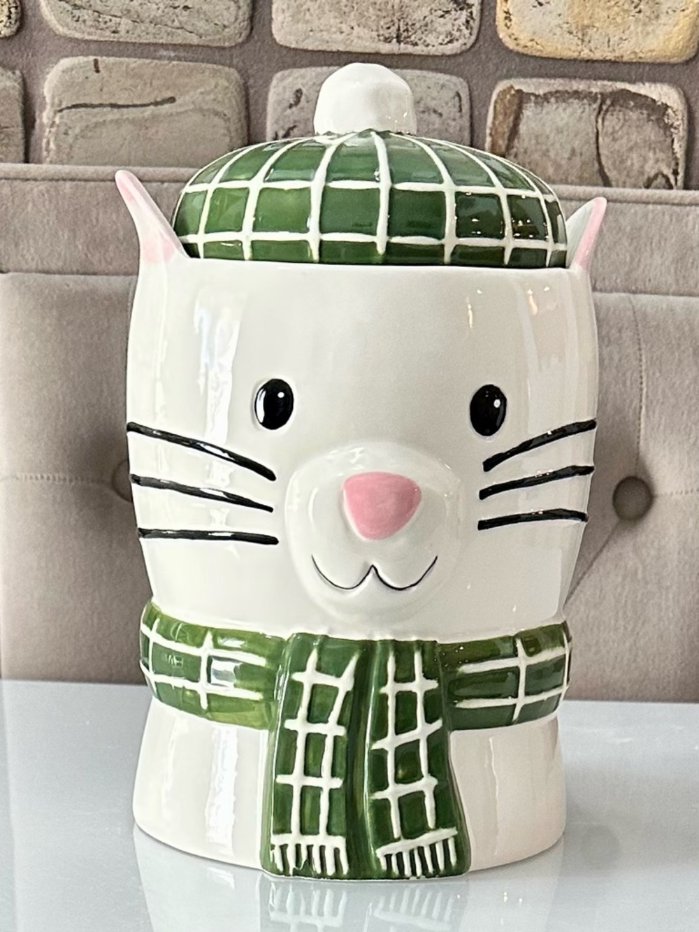 Cat cookie jar with green hat and scarf accents